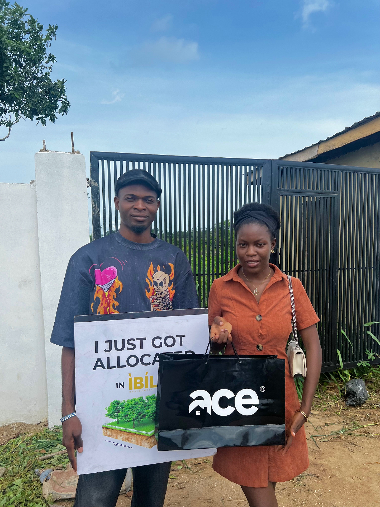 Favour handing over a client allocation package at a project site