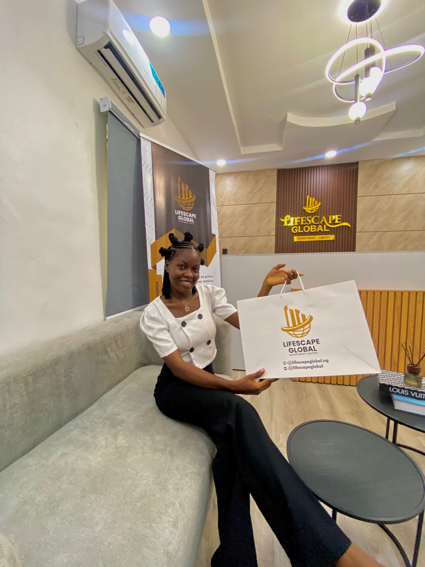 Favour smiling with a client during property allocation on site